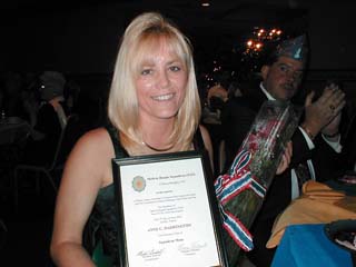 Squadron Mom Anne Harrington with certificate and flowers